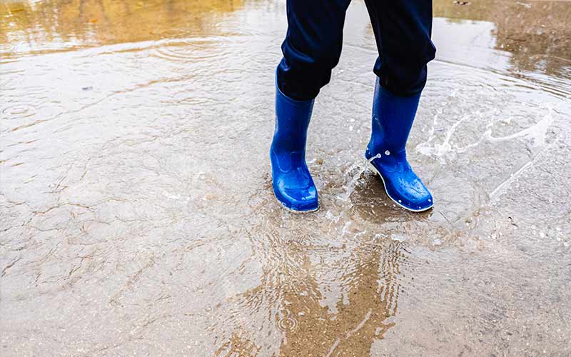 teen splashing in the puddle