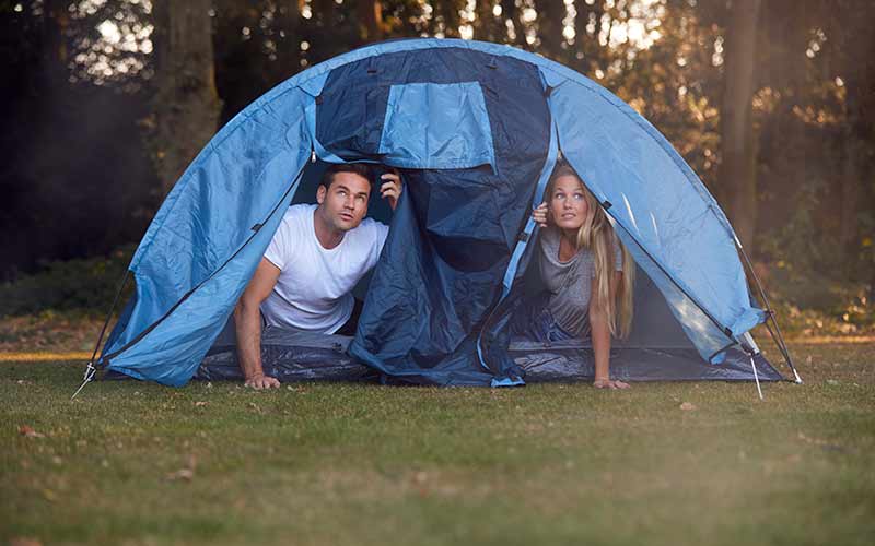 teenagers in a tent on a rainy day