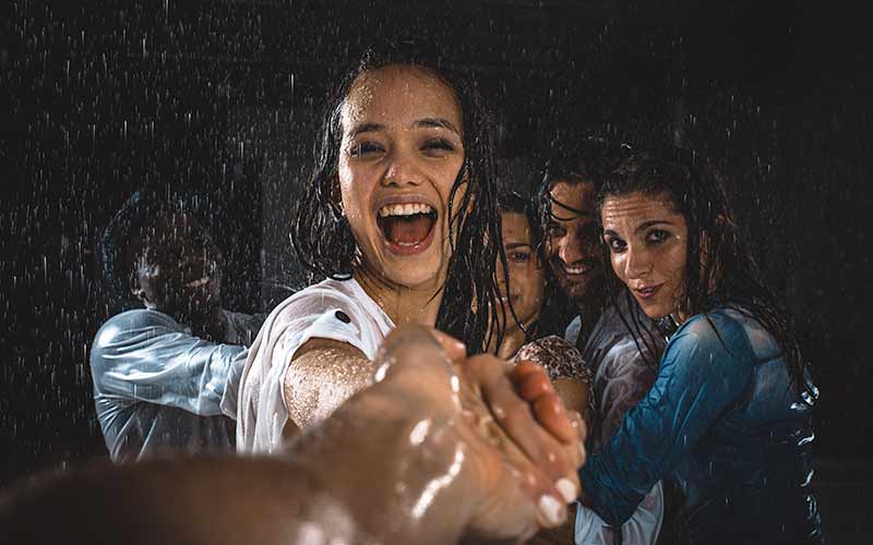 teens dancing in the rain